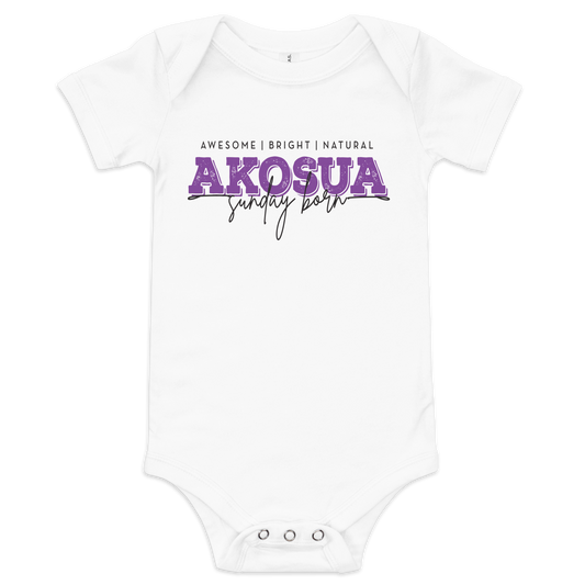 A white short-sleeve baby bodysuit with a graphic print on the chest reading 'AWESOME | BRIGHT | NATURAL AKOSUA sunday born' in purple and black lettering, shown on a plain white background.