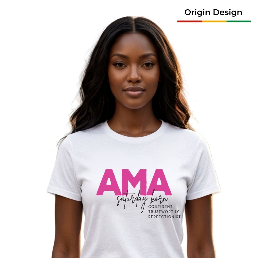 A woman modeling a white crewneck t-shirt with a pink and black graphic that reads 'AMA Saturday Born Confident Trustworthy ,perfectionist.The image has a clean white background.