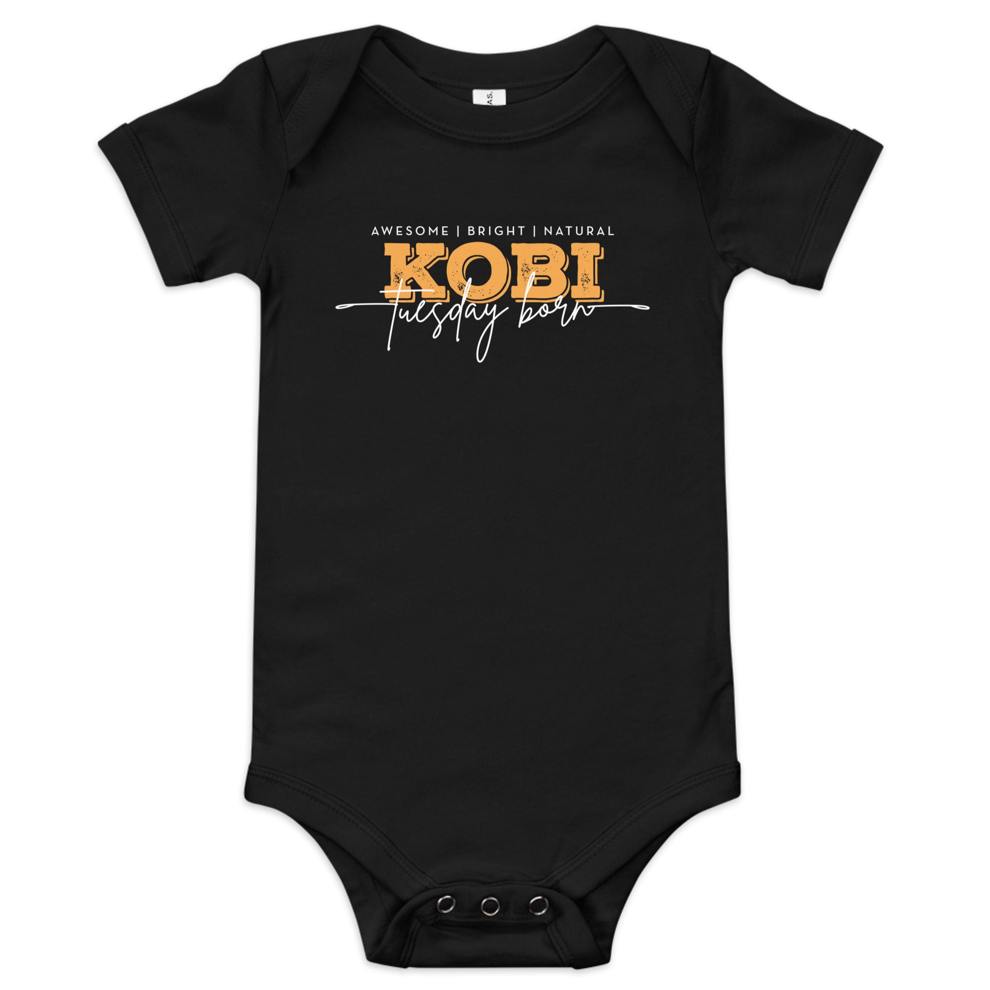 A white short-sleeve baby bodysuit with a graphic print on the chest reading 'AWESOME | BRIGHT | NATURAL KOBI tuesday born' in white and yellow lettering, shown on a plain white background